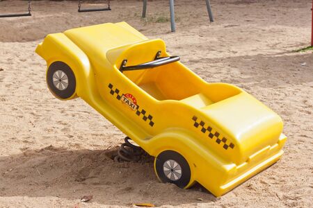 yellow car toy in parkの写真素材