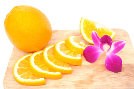 orange and orchid over chopping blockの写真素材