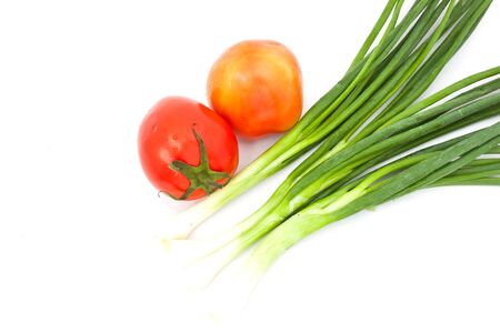 tomatos and leeks over white paperの写真素材