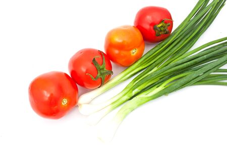 tomatos and leeks over white paperの写真素材