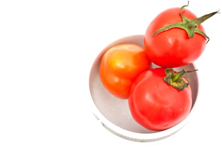 tomatos in chinaware on white paperの写真素材