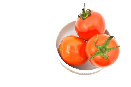 tomatos in chinaware on white paperの写真素材