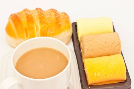 Delicious breads and cup of coffee on white paperの写真素材