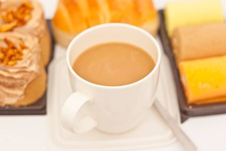 Delicious breads and cup of coffee on white paperの写真素材
