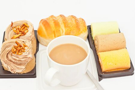 Delicious breads and cup of coffee on white paperの写真素材