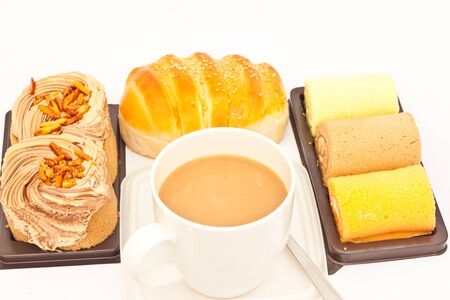 Delicious breads and cup of coffee on white paperの写真素材