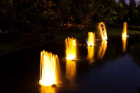 fountain in garden at night timeの写真素材