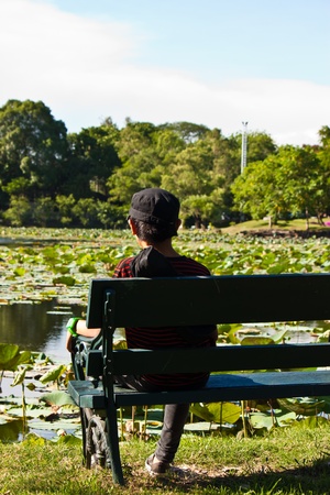 alone children looking at a lotus pondの写真素材