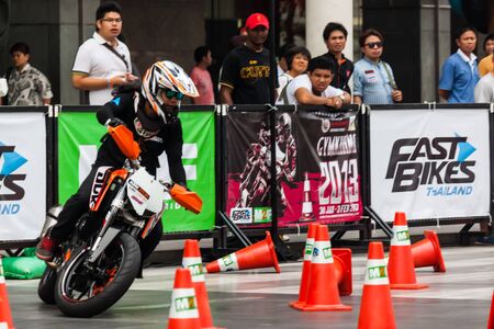 BANGKOK, THAILAND - FEB 1: Strong man show motorcycle stunt riding on Feb 1, 2013 at Central World department store in Thailand. The Central World department store is the main shopping area in central Bangkok.のeditorial素材