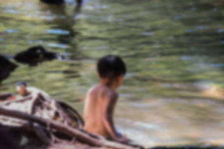 soft blur alone child in waterfall take by lens blurの写真素材