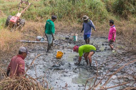 KALASIN, THAILAND - DEC 16 : Agriculturist fishing in small canal on December 16,2016 in Ban Khamin,...