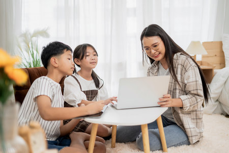 Asian Mother Teaching Children Online Learning on Laptop in white room of Home Happy Smile