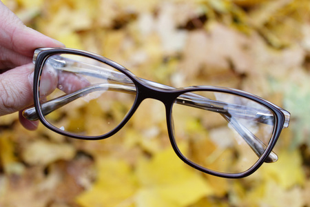 Glasses on the background of autumn yellow leaves. Good photo for the shop or online marketの写真素材