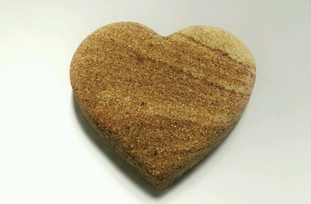 Sandstone shaped like heart in white backgroundの素材