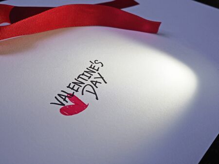 Valentine text on white paper with lightの写真素材