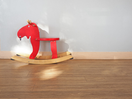 Baby rocking horse on wooden floorの写真素材