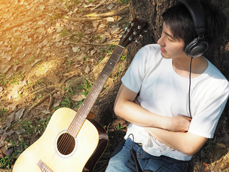 Man listening music in the parkの写真素材