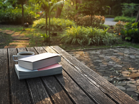 Coffee and books on wood tableの写真素材