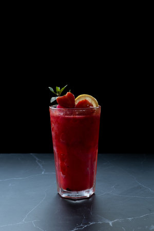 Fruit smoothies, berries, lemon, red, ice crystals, healthy menu, cafe glass black backgroundの写真素材