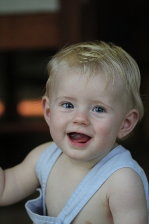Cute baby boy in blue overallsの写真素材