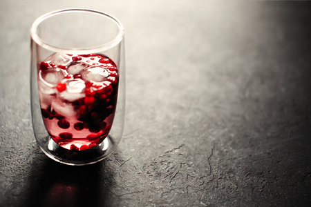 Berry drink with ice on black backgroundの写真素材