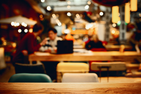 Blurred background in a cafe with people. Lunch time
