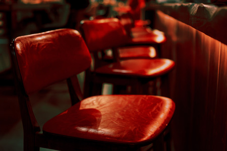 Empty red bar stool in an empty restaurantの写真素材