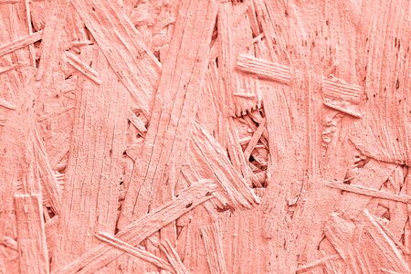 Wooden table top view close-up coral color background