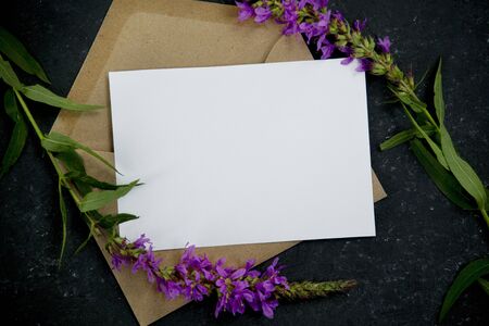 Minimal composition with envelope with purple flowers