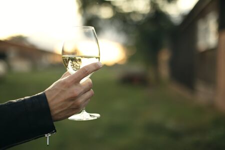 Man white wine in the hand, travel holidays, new places