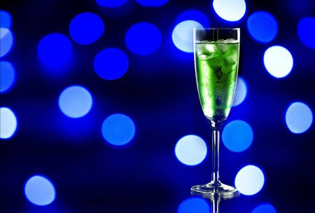 Glass of red champagne with ice on black backgroundの写真素材