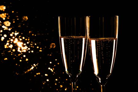 Glasses with champagne on black background, New Year backgroundの写真素材