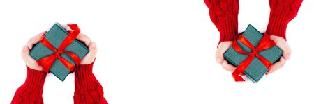 Children hands holding present box on white background. Flat lay, top view. Concept banner