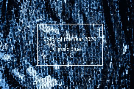 Cloth with neon blue paillettes. Background texture, new year and holiday