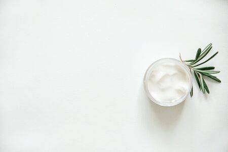 Herbal dermatology, hygienic cream skincare product in glass jar on white background