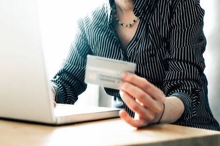 Hand holding credit card and and makes online shopping