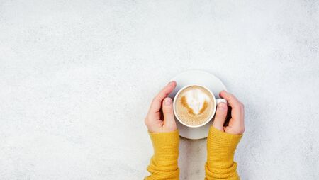 Hand and cup of coffee, white color backgroundの写真素材