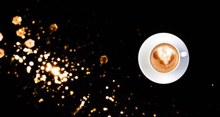 Coffee in a cup view from above on black color backgroundの写真素材