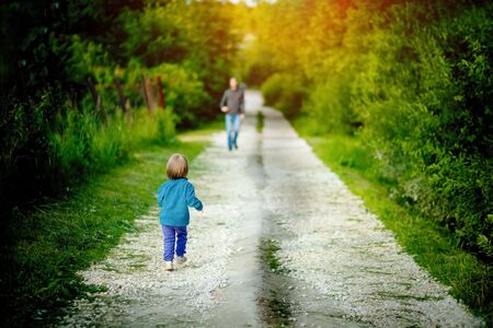 The daughter runs to meet his dad after the end of quarantineの写真素材