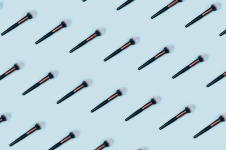 Cosmetic makeup brush on blue color background, top view patternの写真素材