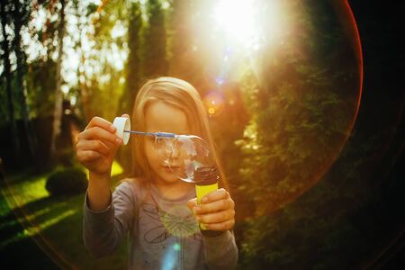 Girl blow bubbles, expectation of summer outdoor recreation, quarantine holidayの写真素材