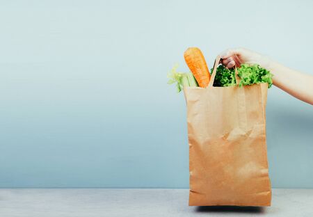 Paper bag with fresh ripe organic vegetables, vegetables delivery during a pandemicの写真素材