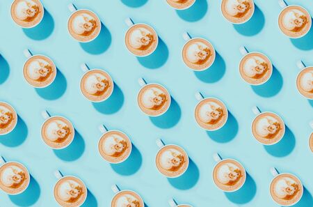 A cup of coffee on a blue background, top view flatlay patternの写真素材
