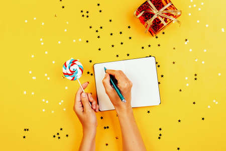 Girl writes wishes on New Year's Eve 2021, the concept of waiting for a holiday