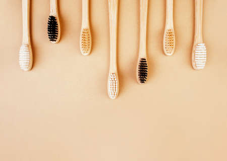 Eco-friendly bamboo toothbrushes on beige background. Natural organic bathroom beauty product concept. Flat lay, top view, copy spaceの写真素材