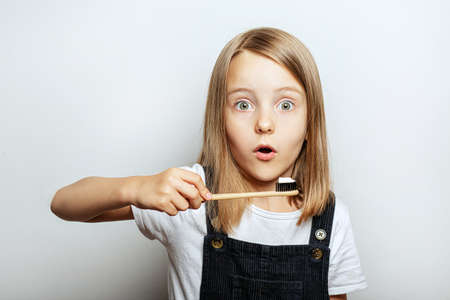 A child with a toothbrush in his hands, the childs habit of brushing teeth in the morning and in the eveningの写真素材