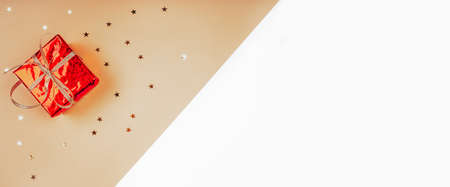 Glitters and present on a pink background, christmas and new year fun concept