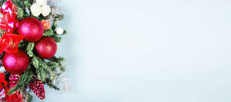 Christmas tree branches with red decorations on blue backgroundの写真素材