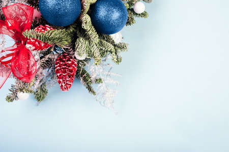 Christmas tree branches with decorations on blue backgroundの写真素材