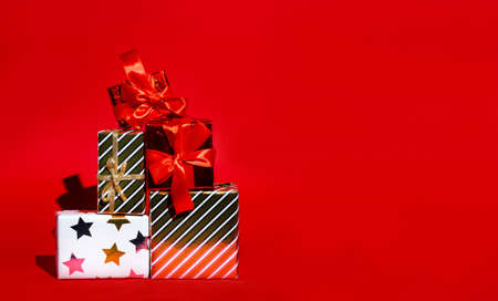 Boxes with New Years gifts on red background with space for text, concept of new year cardの写真素材